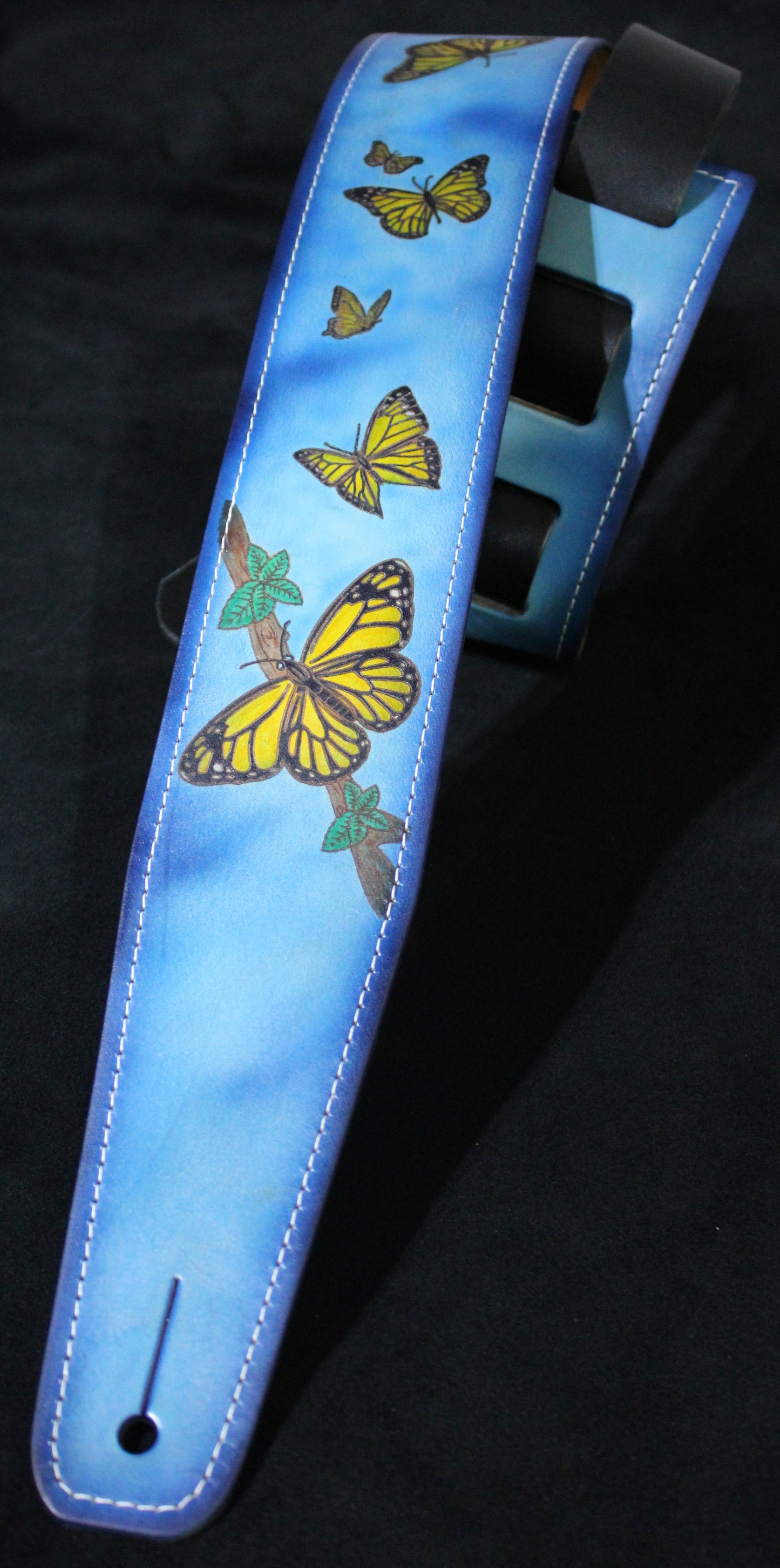 Guitar strap with butterfly design leather blue sky back ground