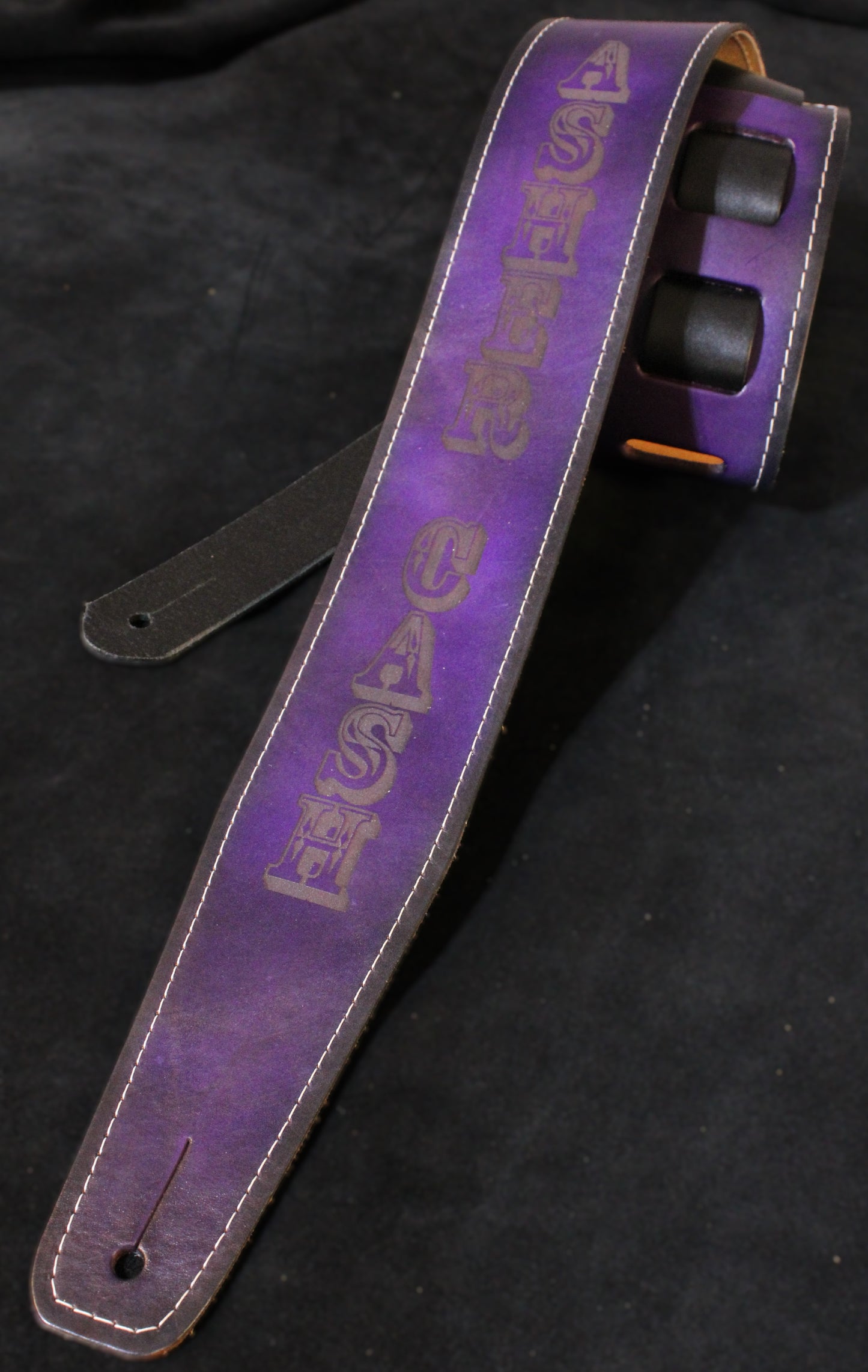 Stitched purple leather guitar strap